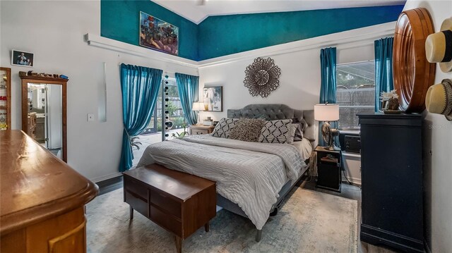 1130 Woodsong Way, Clermont, FL 34714 - bedroom featuring wood finished floors, a towering ceiling, and baseboards
