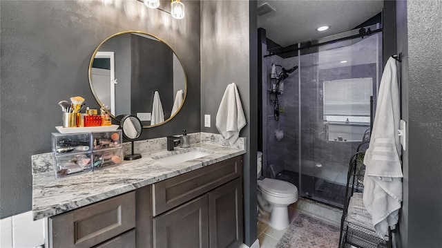 1130 Woodsong Way, Clermont, FL 34714 - full bath featuring vanity, a stall shower, a textured wall, toilet, and tile patterned floors