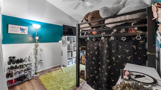 1130 Woodsong Way, Clermont, FL 34714 - bedroom with wood finished floors and lofted ceiling