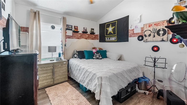 1130 Woodsong Way, Clermont, FL 34714 - bedroom with vaulted ceiling and wood finished floors