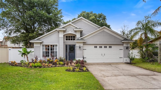 1130 Woodsong Way, Clermont, FL 34714 - view of front of property featuring driveway, an attached garage, and stucco siding