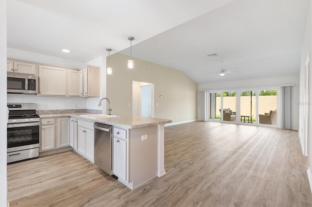 4157 Tiedemann Loop, The Villages, FL 32163 - kitchen with appliances with stainless steel finishes, a sink, vaulted ceiling, open floor plan, and a peninsula