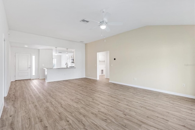 4157 Tiedemann Loop, The Villages, FL 32163 - unfurnished living room with a ceiling fan, light wood-style floors, lofted ceiling, and baseboards