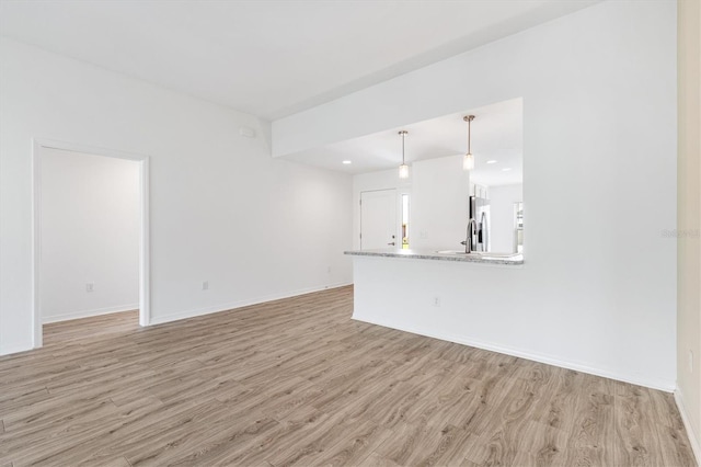 4157 Tiedemann Loop, The Villages, FL 32163 - unfurnished living room with light wood-style floors, baseboards, and recessed lighting