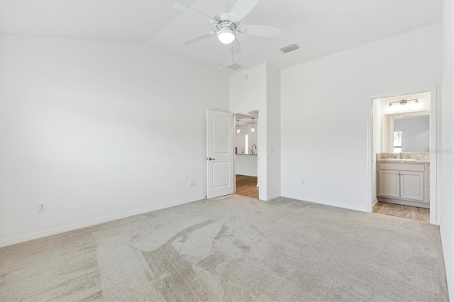 4157 Tiedemann Loop, The Villages, FL 32163 - unfurnished bedroom featuring light colored carpet, lofted ceiling, a sink, baseboards, and ensuite bathroom