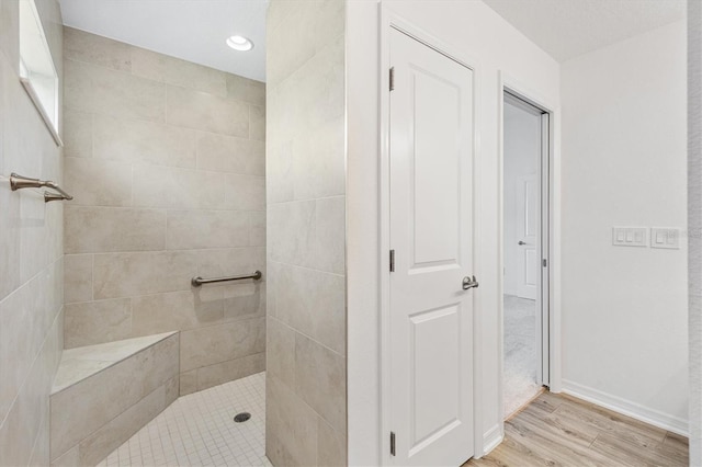 4157 Tiedemann Loop, The Villages, FL 32163 - bathroom with walk in shower, wood finished floors, and baseboards