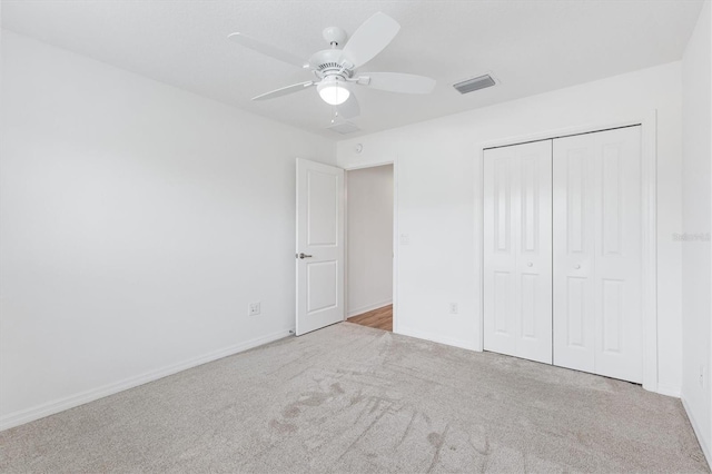 4157 Tiedemann Loop, The Villages, FL 32163 - unfurnished bedroom with carpet, a closet, baseboards, and a ceiling fan