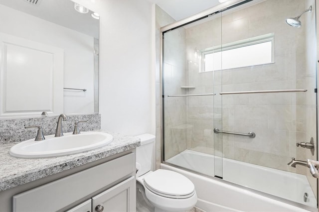 4157 Tiedemann Loop, The Villages, FL 32163 - bathroom with vanity, toilet, and shower / bath combination with glass door