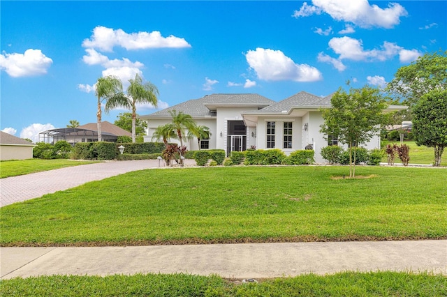 39145 Treeline Dr, Lady Lake, FL 32159 - view of front of property with stucco siding, driveway, and a front yard