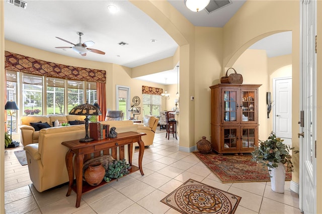 39145 Treeline Dr, Lady Lake, FL 32159 - living area featuring ceiling fan, arched walkways, light tile patterned flooring, and baseboards