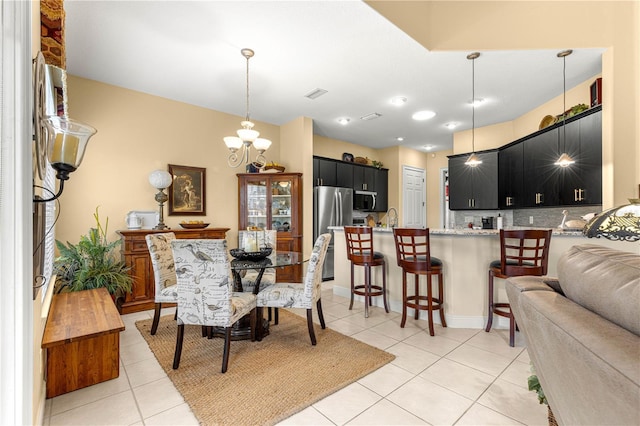 39145 Treeline Dr, Lady Lake, FL 32159 - dining area featuring light tile patterned floors and a chandelier