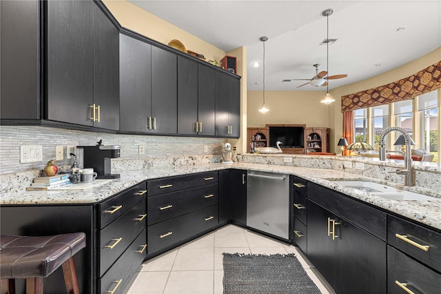 39145 Treeline Dr, Lady Lake, FL 32159 - kitchen with stainless steel dishwasher, a sink, dark cabinetry, a ceiling fan, and light tile patterned floors