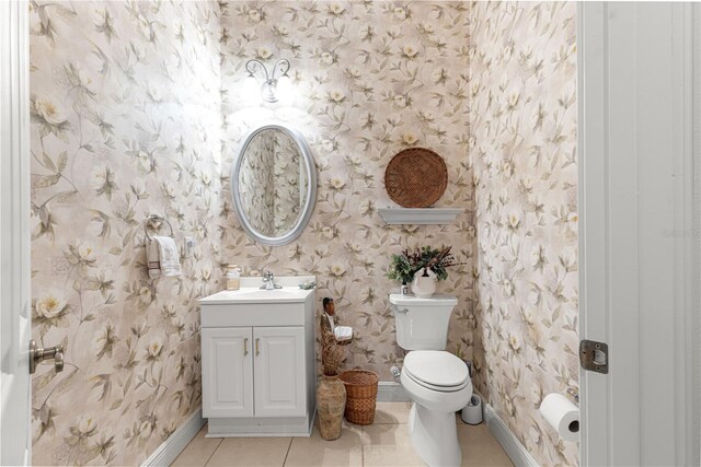 39145 Treeline Dr, Lady Lake, FL 32159 - half bathroom with wallpapered walls, toilet, baseboards, vanity, and tile patterned flooring