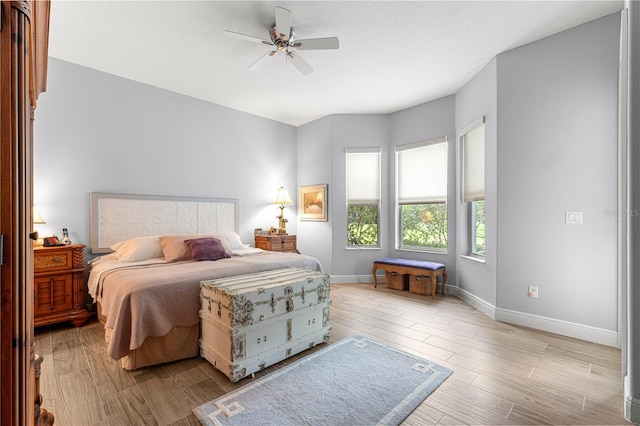 39145 Treeline Dr, Lady Lake, FL 32159 - bedroom with baseboards, wood finished floors, and a ceiling fan