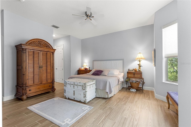 39145 Treeline Dr, Lady Lake, FL 32159 - bedroom with light wood-style floors, baseboards, and a ceiling fan