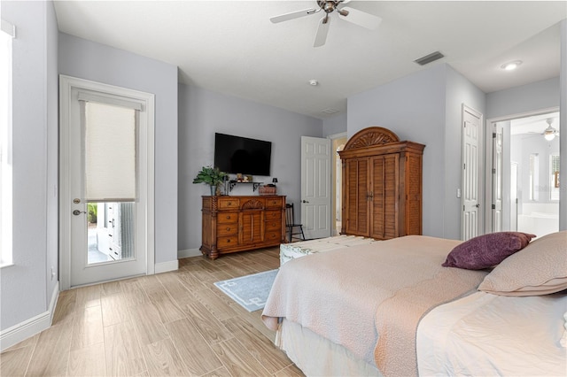 39145 Treeline Dr, Lady Lake, FL 32159 - bedroom featuring baseboards, access to outside, ceiling fan, and ensuite bathroom