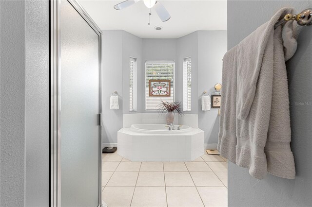 39145 Treeline Dr, Lady Lake, FL 32159 - full bathroom featuring tile patterned floors, a ceiling fan, a garden tub, and a shower stall
