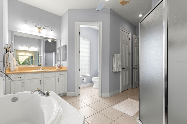 39145 Treeline Dr, Lady Lake, FL 32159 - bathroom with ceiling fan, vanity, toilet, a bath, and tile patterned flooring