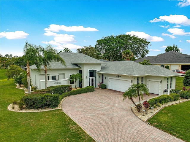 39145 Treeline Dr, Lady Lake, FL 32159 - single story home with an attached garage, stucco siding, decorative driveway, a front lawn, and a shingled roof