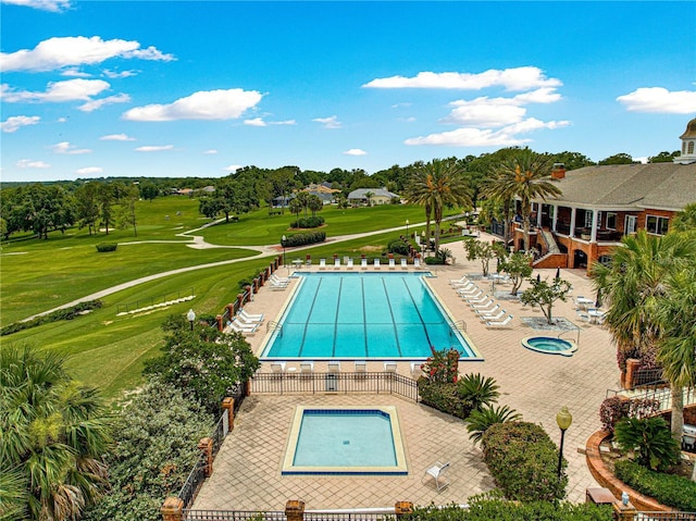 39145 Treeline Dr, Lady Lake, FL 32159 - community pool featuring a patio, a yard, and golf course view