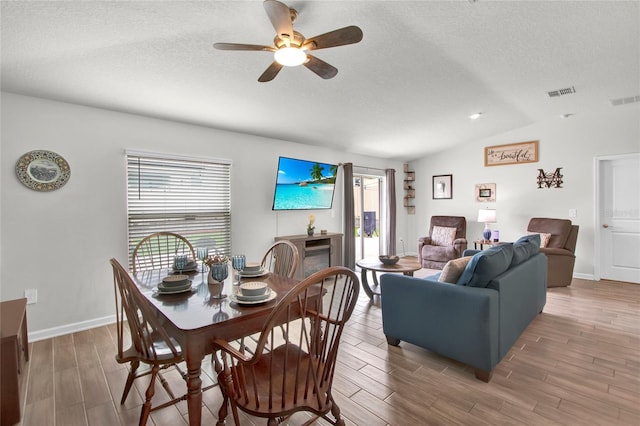 733 Citrus Reserve Blvd, Davenport, FL 33837 - dining room featuring wood finished floors, lofted ceiling, a ceiling fan, a textured ceiling, and baseboards