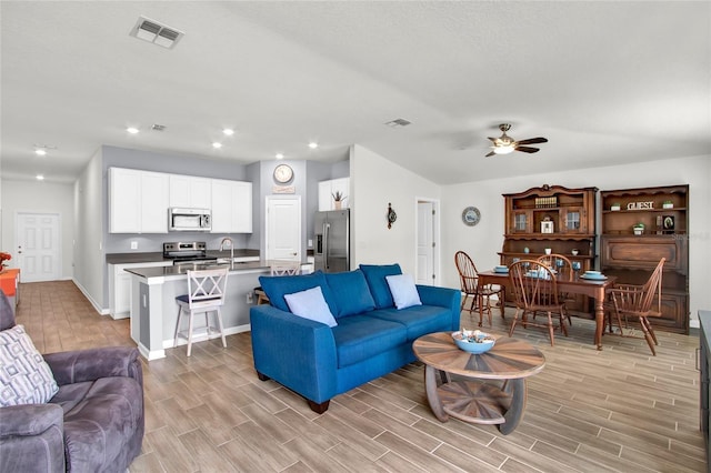 733 Citrus Reserve Blvd, Davenport, FL 33837 - living room featuring baseboards, light wood-type flooring, ceiling fan, and recessed lighting