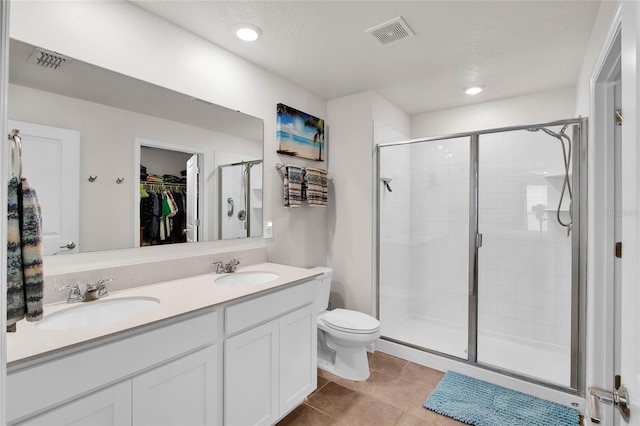 733 Citrus Reserve Blvd, Davenport, FL 33837 - full bathroom featuring a shower stall, a walk in closet, double vanity, toilet, and recessed lighting