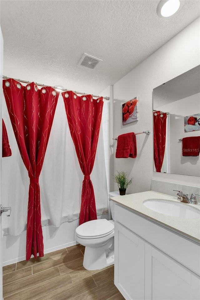 733 Citrus Reserve Blvd, Davenport, FL 33837 - full bathroom with wood finished floors, vanity, toilet, a textured ceiling, and shower / tub combo