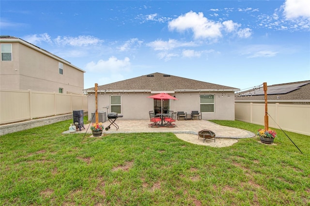 733 Citrus Reserve Blvd, Davenport, FL 33837 - rear view of property featuring a patio, stucco siding, central AC unit, a fire pit, and roof with shingles