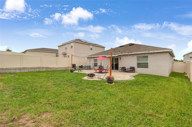 733 Citrus Reserve Blvd, Davenport, FL 33837 - rear view of house featuring a patio, an outdoor fire pit, stucco siding, central AC unit, and a shingled roof
