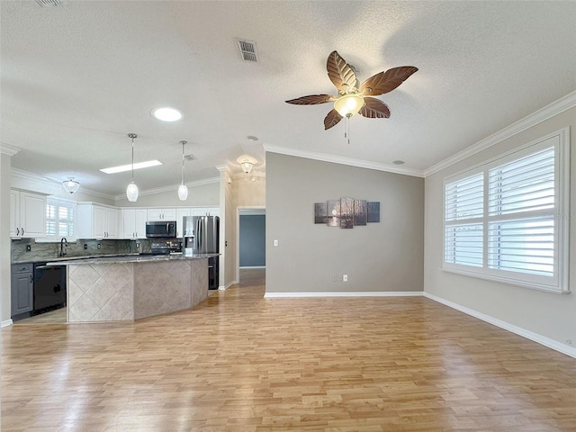 3237 Atwell Ave, The Villages, FL 32162 - kitchen with appliances with stainless steel finishes, open floor plan, a sink, light wood finished floors, and lofted ceiling