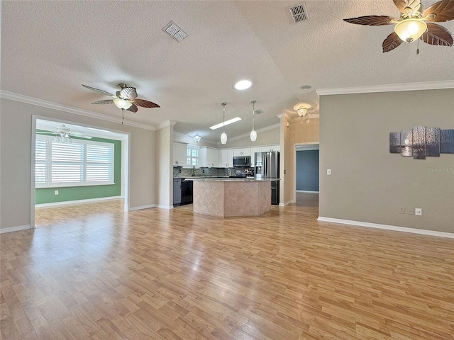 3237 Atwell Ave, The Villages, FL 32162 - unfurnished living room featuring a ceiling fan, a textured ceiling, light wood-style flooring, vaulted ceiling, and baseboards