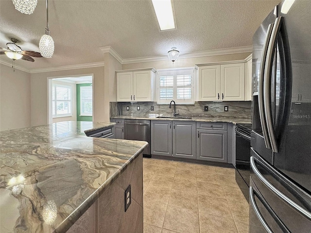 3237 Atwell Ave, The Villages, FL 32162 - kitchen with stainless steel appliances, gray cabinets, a sink, plenty of natural light, and ornamental molding