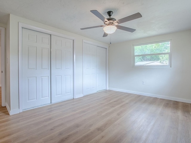 59 S Columbus St, Beverly Hills, FL 34465 - unfurnished bedroom with light wood finished floors, multiple closets, baseboards, and a ceiling fan