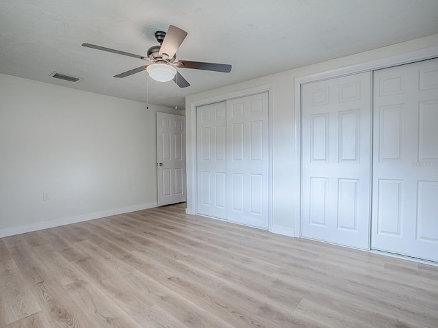 59 S Columbus St, Beverly Hills, FL 34465 - unfurnished bedroom featuring two closets, light wood finished floors, baseboards, and ceiling fan