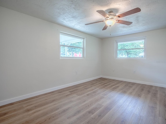 59 S Columbus St, Beverly Hills, FL 34465 - empty room with wood finished floors, baseboards, ceiling fan, and a textured ceiling