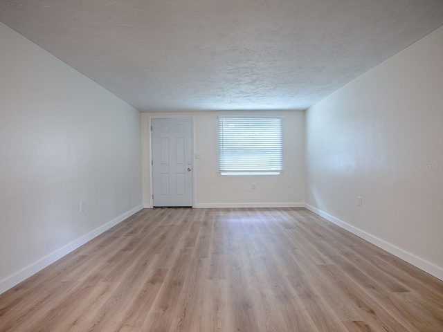 59 S Columbus St, Beverly Hills, FL 34465 - unfurnished room featuring light wood finished floors, baseboards, and a textured ceiling