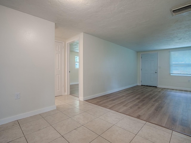 59 S Columbus St, Beverly Hills, FL 34465 - spare room featuring a textured ceiling, light tile patterned flooring, baseboards, and plenty of natural light