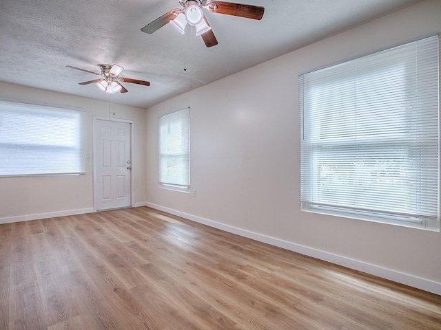 59 S Columbus St, Beverly Hills, FL 34465 - unfurnished room featuring ceiling fan, baseboards, light wood-style floors, plenty of natural light, and a textured ceiling