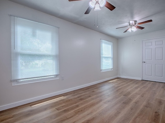 59 S Columbus St, Beverly Hills, FL 34465 - spare room featuring a ceiling fan, light wood-style floors, baseboards, and a textured ceiling