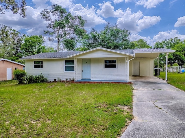 59 S Columbus St, Beverly Hills, FL 34465 - ranch-style home featuring a front lawn, driveway, a carport, and brick siding