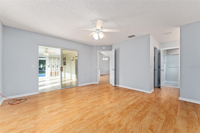 2557 Privada Dr, The Villages, FL 32162 - empty room with ceiling fan, light wood-style floors, a textured ceiling, and baseboards