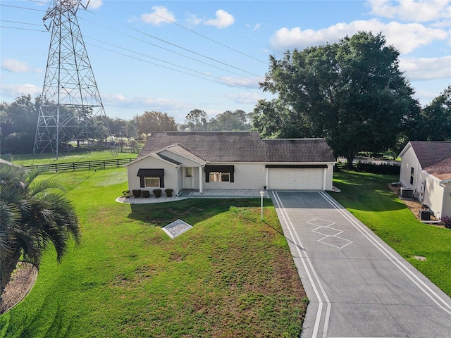 2557 Privada Dr, The Villages, FL 32162 - view of front of property with an attached garage, driveway, a shingled roof, and cooling unit