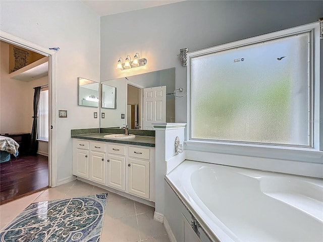 1034 Copenhagen Way, Winter Garden, FL 34787 - full bathroom with vanity, plenty of natural light, a bath, and tile patterned floors