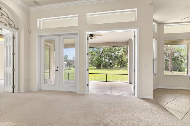 29152 David Ct, Tavares, FL 32778 - doorway featuring french doors, crown molding, plenty of natural light, carpet floors, and tile patterned floors