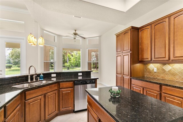 29152 David Ct, Tavares, FL 32778 - kitchen featuring stainless steel dishwasher, decorative backsplash, dark stone counters, brown cabinets, and ornamental molding