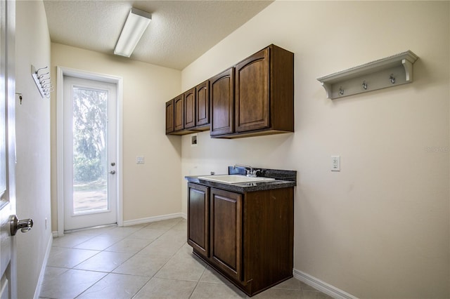 29152 David Ct, Tavares, FL 32778 - washroom featuring a textured ceiling, cabinet space, washer hookup, and light tile patterned flooring