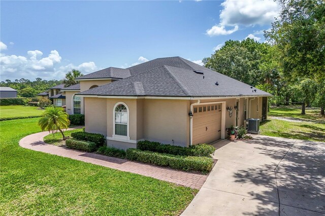 29152 David Ct, Tavares, FL 32778 - view of property exterior featuring stucco siding, a shingled roof, a yard, a garage, and concrete driveway