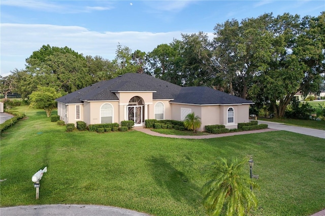 29152 David Ct, Tavares, FL 32778 - view of front facade with stucco siding and a front yard