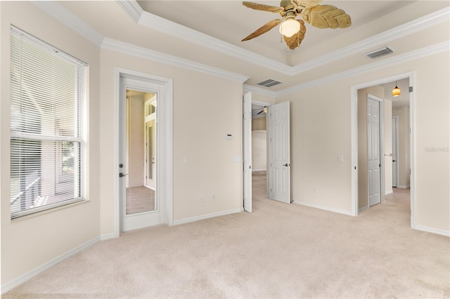 29152 David Ct, Tavares, FL 32778 - unfurnished bedroom with light carpet, ornamental molding, a tray ceiling, and ceiling fan